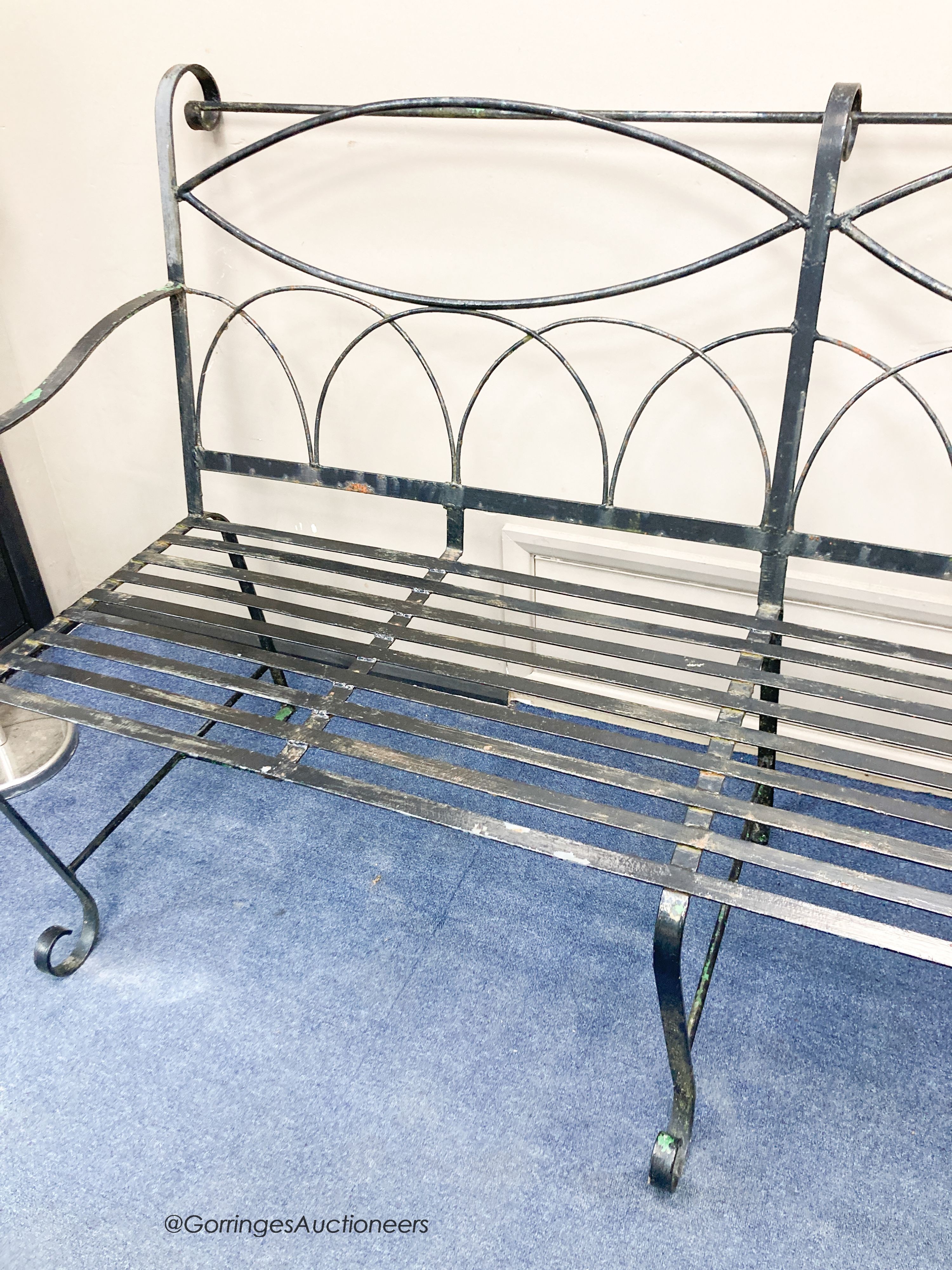 A painted wrought iron garden bench, length 175cm, depth 83cm, height 110cm